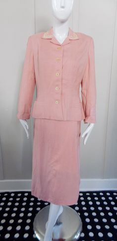 "Pale pink linen suit  Collar is decorated with cream satin stitch embroidery Notched collar Self covered shoulder pads Unlined Seam allowances have been turned under and blind hemmed Bound buttonholes Belt loops but no belt Two front pockets at hem  Turned up wing cuffs Two piece sleeve Princess seaming and darts Skirt has side lapped metal Crown zipper Corded buttonhole and pink button Skirt is unlined and the seam allowances are pinked  Back walking pleat Labelled \"Ever-Lure tailored by Wall Bound Buttonholes, Linen Skirt Suit, Satin Stitch Embroidery, 1940s Fashion Dresses, Green Plaid Dress, Plaid Wool Skirt, 40s Dress, Metal Crown, Suit Collar