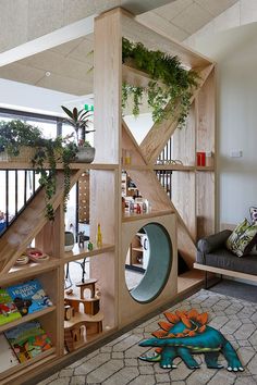 a living room with bookshelves and plants on the shelves in front of it