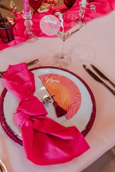 the table is set for valentine's day with pink napkins and silverware