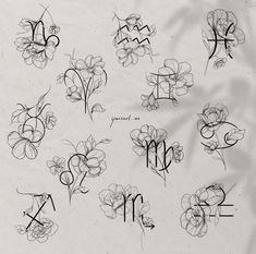 the letters and numbers are drawn with black ink on a sheet of paper that has flowers in it