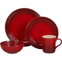 red dinnerware set with matching cups and saucers