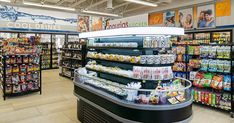 the inside of a grocery store filled with lots of food and drink bottles on display