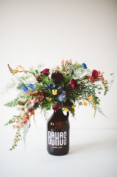 a vase filled with lots of flowers on top of a table