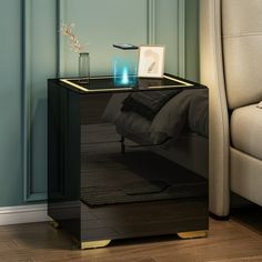 a night stand with a black and gold finish