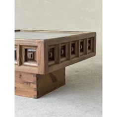 a wooden table that has some kind of design on it's top and bottom