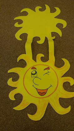 a paper cut out of the face of a smiling sun