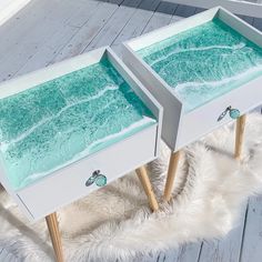 two white and green tables with drawers sitting on top of a furnishing rug