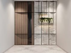 the entrance to an office building with marble and wood panels on the walls, along with plants