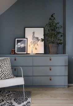 an instagram photo of a room with blue walls and furniture