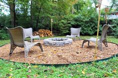 an outdoor fire pit surrounded by chairs and logs