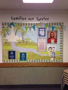 a bulletin board with pictures on it in an office cubicle area that says families are forever