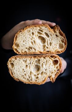 two pieces of bread being held in their hands