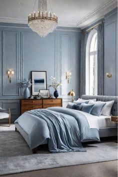 a bedroom with blue walls and white bedding, chandelier, chair, dresser and window