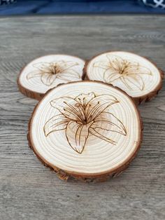 three pieces of wood with flowers carved on them