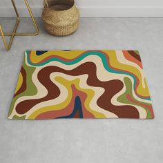 a colorful rug on the floor next to a basket