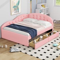 a pink bed with two drawers underneath it in a child's playroom or bedroom