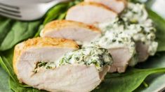 slices of pork with spinach and cream sauce on a plate