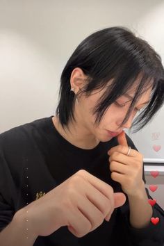 a woman is brushing her teeth with an electric toothbrush