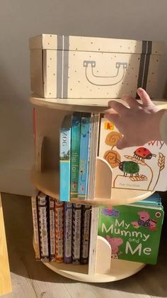 a child's book shelf with books on it