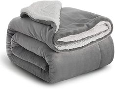 two blankets folded on top of each other with white and gray sheets in the middle