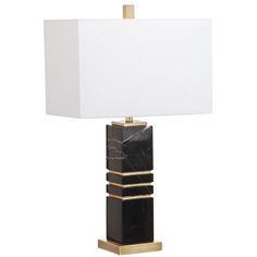 a black and gold table lamp with a white shade on the top, in front of a white background