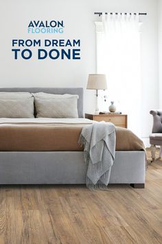 a bedroom with wood flooring and a large bed in the center, along with a wall sticker that reads'from dream to donee '