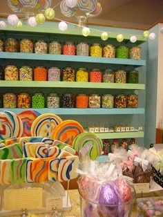 the candy shop is filled with lots of colorful candies and lollipops