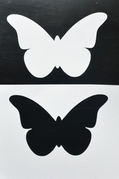 two butterfly decals sitting on top of each other