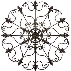 a circular metal object with vines and leaves on it's center, set against a white background