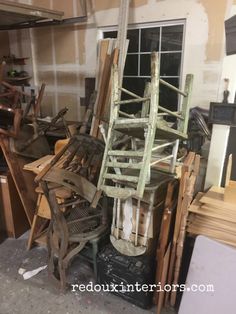 a pile of old wooden chairs sitting next to each other