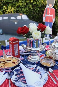 a table topped with plates and silverware covered in red, white and blue food