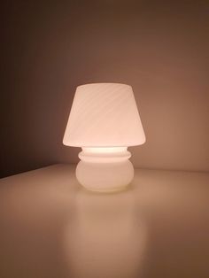 a white lamp sitting on top of a table