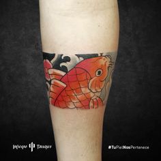 an orange fish tattoo on the leg