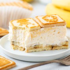 a piece of cake sitting on top of a white plate next to some crackers