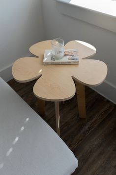 a small table with a book and cup on it