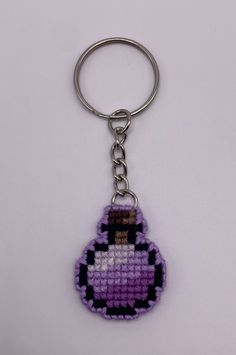 a keychain made to look like an old school computer game character