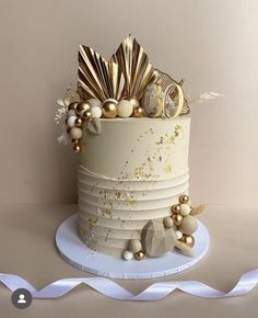 a white cake with gold decorations on top