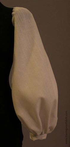 a black and white dress on display next to a mannequin's torso