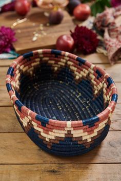 a woven basket sitting on top of a wooden table