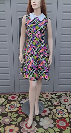 Vintage 60's Adorable flower print  midi dress.  Zips up the back.  The material feel like a light weight polished cotton.  Bursting with colors, great little summer number . Label: Liberty Circle   B. Altman & Company Measurements are taken with item laying flat so widths across must be doubled  Length = 38 in Across under arms =  17.5 in Across the Waist =  14.5   in Across the Hips =  20 in Please be sure to use the measurements to help determine if this will be a good fit for you. You can al Cotton Dresses With Retro Print For Summer, Cotton Retro Midi Dress For Garden Party, Retro Cotton Midi Dress For Garden Party, Patterned Retro Print Summer Dress, Vintage Printed Midi Dress For Spring, Sleeveless Floral Print Vintage Dress For Spring, Vintage Sleeveless Patterned Dress, Vintage Patterned Summer Dresses, Sleeveless Vintage Dress With Floral Print For Summer