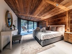 a bedroom with wood paneling and white furniture