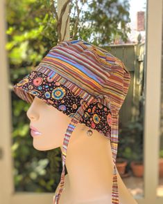 a mannequin head wearing a multicolored hat