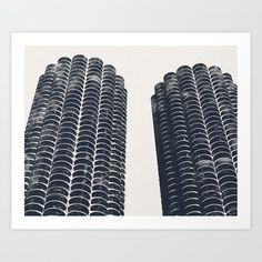 two black and white photograph of tall buildings