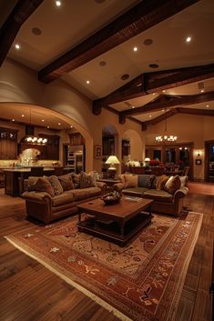 a living room filled with furniture and a large rug on top of a hard wood floor