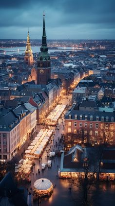 an aerial view of a city at night with christmas lights on the streets and large buildings