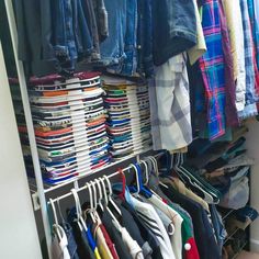 a closet filled with lots of clothes and shirts