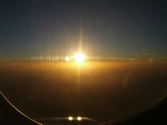 the sun shines brightly through an airplane window