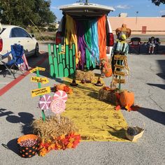 an outdoor area decorated for halloween with pumpkins and hay