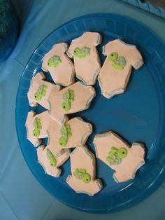 there are many decorated cookies in the shape of turtle's on a blue plate