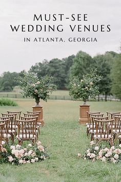 an outdoor wedding venue set up with wooden chairs and flowers in vases on the grass